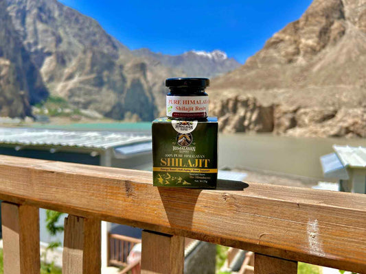 Himalayan Elixirs vegan Shilajit resin jar with Attabad Lake in background